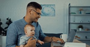 Dad working at home with baby