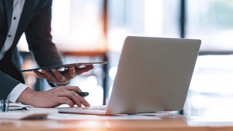 A busy recruiter on a tablet and laptop